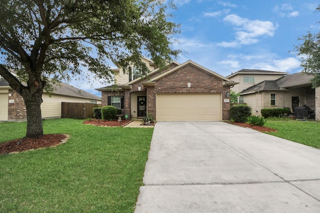 traditional-style home with a front lawn, a garage, brick siding, concrete driveway, and fence