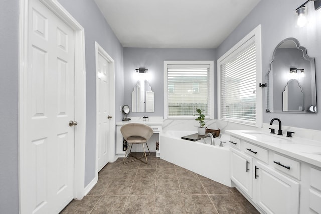 full bath with tile patterned flooring, a bath, and vanity