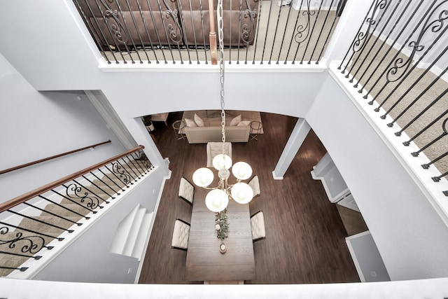 stairs featuring an inviting chandelier and a towering ceiling