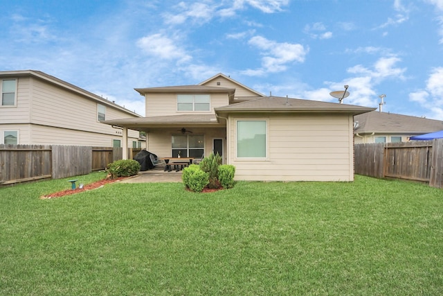 back of house featuring a fenced backyard, a ceiling fan, a yard, and a patio area