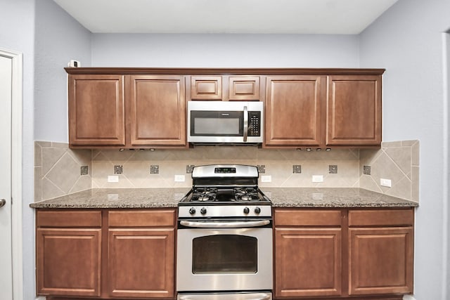kitchen featuring light stone counters, stainless steel appliances, decorative backsplash, and brown cabinetry