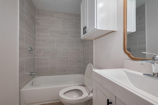 full bathroom featuring toilet, shower / bath combination, a textured ceiling, and vanity
