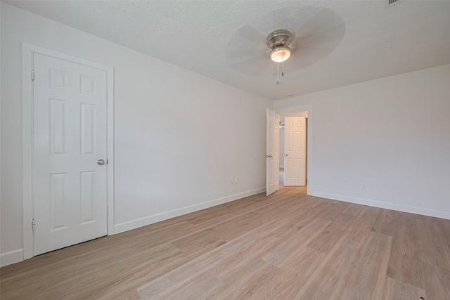 unfurnished room with baseboards, a ceiling fan, and light wood finished floors