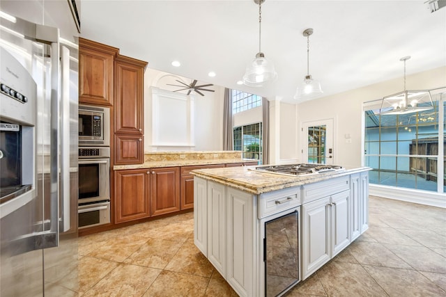 kitchen with brown cabinetry, stainless steel appliances, and hanging light fixtures