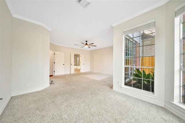 unfurnished room with visible vents, ceiling fan, baseboards, carpet floors, and ornamental molding