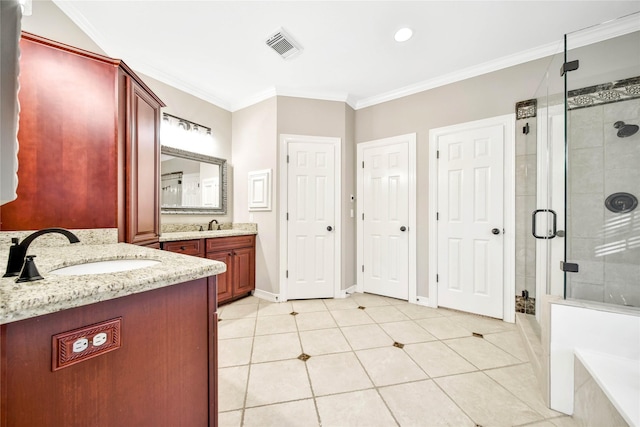 full bath with ornamental molding, a sink, a shower stall, and visible vents