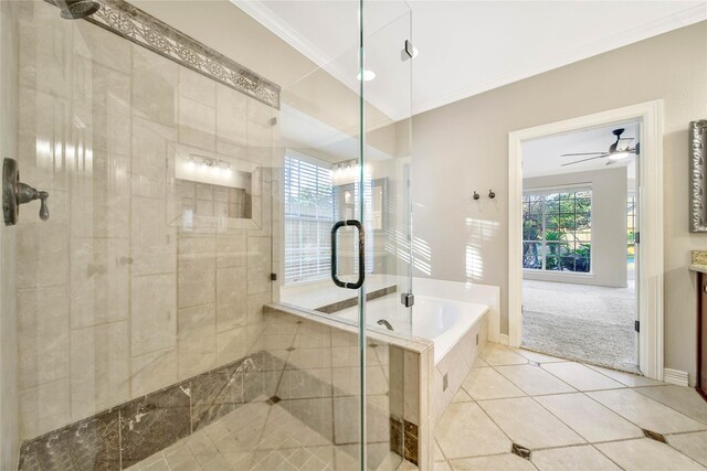 bathroom featuring tile patterned flooring, a stall shower, a ceiling fan, a garden tub, and crown molding