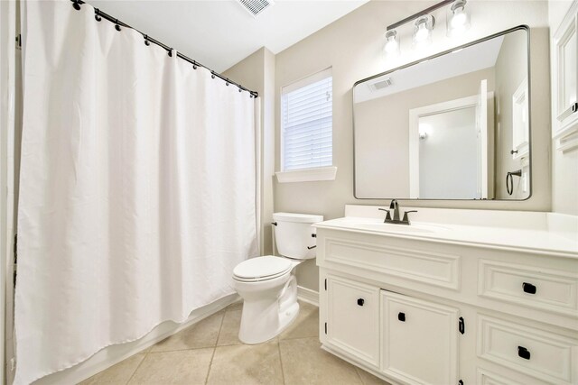 bathroom with tile patterned floors, visible vents, toilet, and vanity