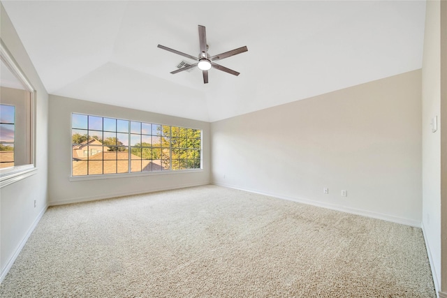 carpeted spare room featuring a ceiling fan, lofted ceiling, and baseboards