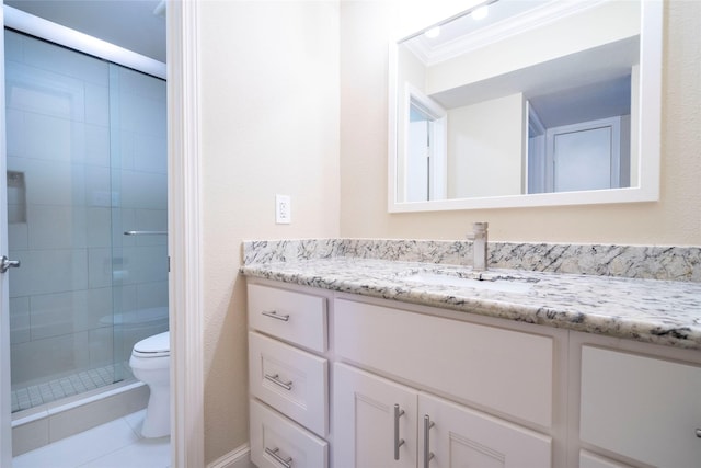 full bath featuring vanity, tile patterned floors, toilet, a stall shower, and crown molding