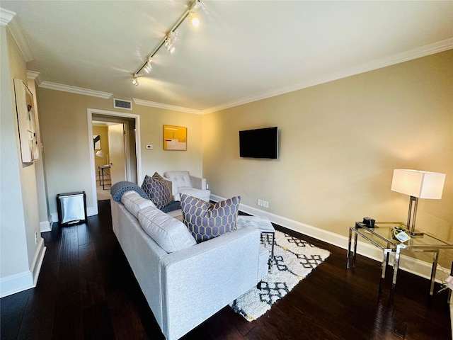 living area featuring visible vents, hardwood / wood-style floors, baseboards, ornamental molding, and track lighting