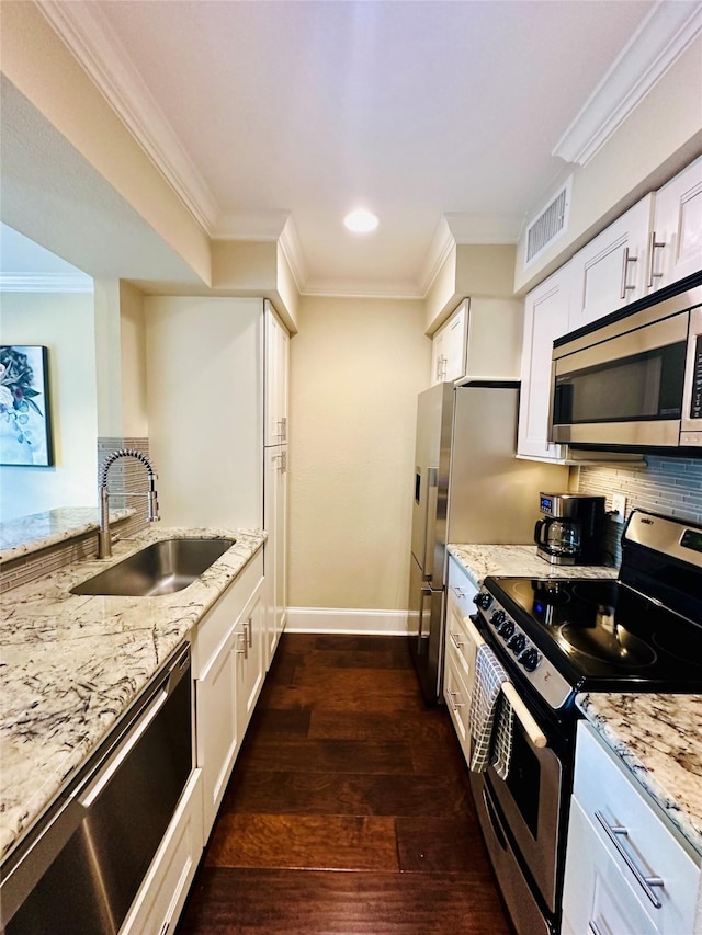 kitchen featuring visible vents, ornamental molding, appliances with stainless steel finishes, and a sink