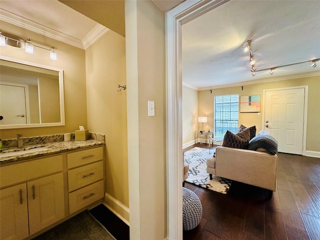bathroom with baseboards, ornamental molding, and wood-type flooring