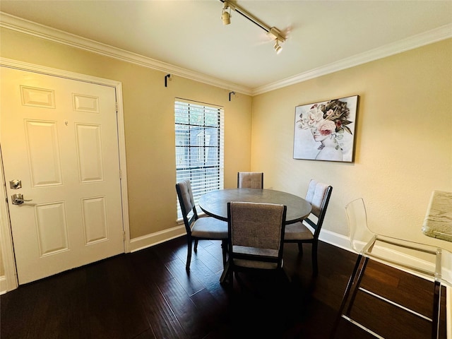 dining space with track lighting, baseboards, dark wood-style flooring, and crown molding