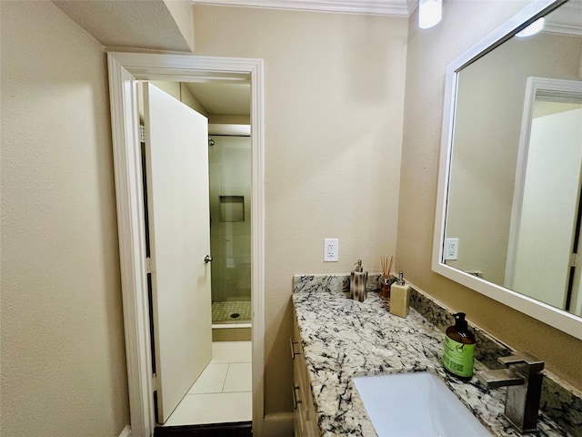 bathroom featuring tile patterned flooring, a shower stall, and vanity