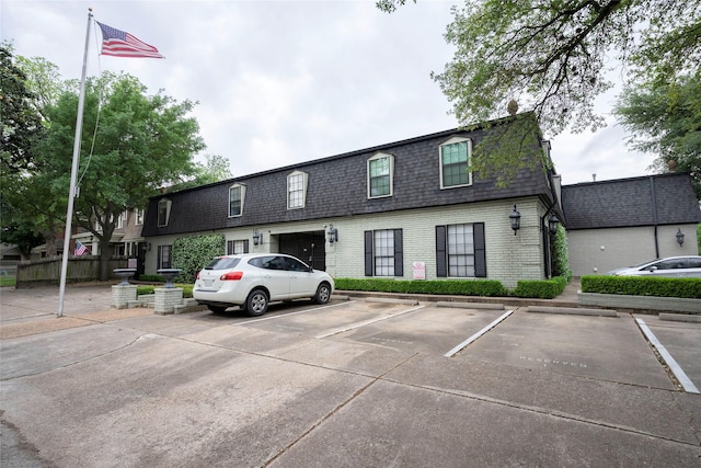 view of property featuring uncovered parking