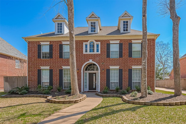 1510 Pecan Trace Ct, Sugar Land, TX 77479 - colonial inspired home featuring brick siding, fence, and a front yard