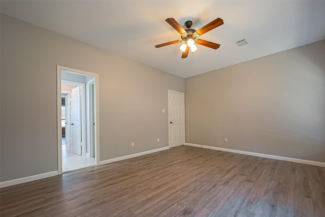 1510 Pecan Trace Ct, Sugar Land, TX 77479 - unfurnished room with a ceiling fan, visible vents, baseboards, and dark wood finished floors