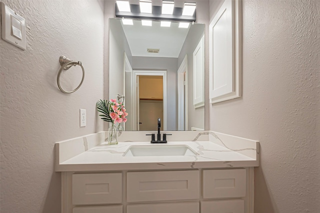 1510 Pecan Trace Ct, Sugar Land, TX 77479 - bathroom featuring a textured wall and vanity