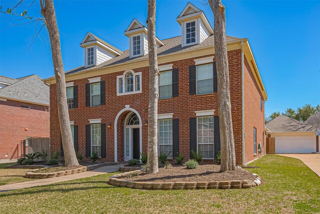 1510 Pecan Trace Ct, Sugar Land, TX 77479 - georgian-style home with a garage, brick siding, and a front lawn