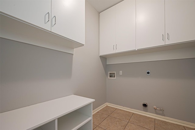 1510 Pecan Trace Ct, Sugar Land, TX 77479 - laundry room featuring washer hookup, light tile patterned floors, electric dryer hookup, baseboards, and cabinet space