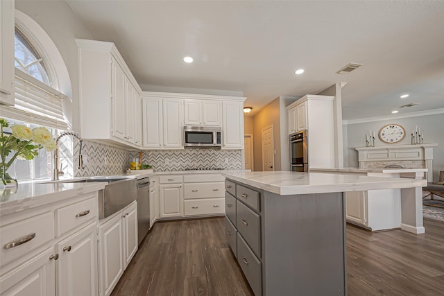 1510 Pecan Trace Ct, Sugar Land, TX 77479 - kitchen with gray cabinetry, stainless steel appliances, and white cabinetry