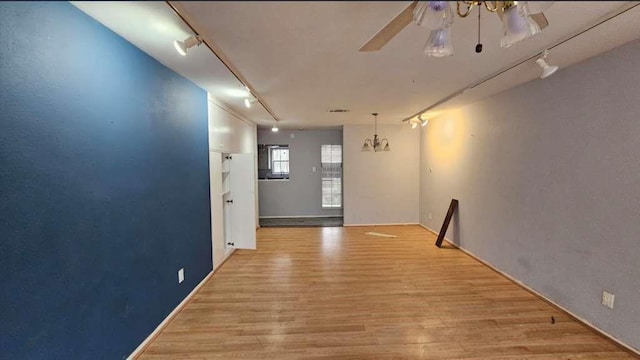 hall featuring rail lighting and light wood-style flooring