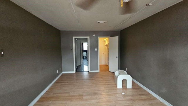spare room with visible vents, baseboards, and light wood-type flooring