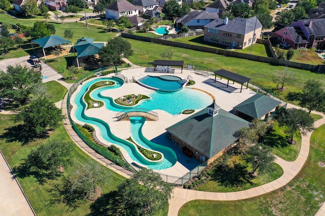 aerial overview of property's location with a pool area and nearby suburban area