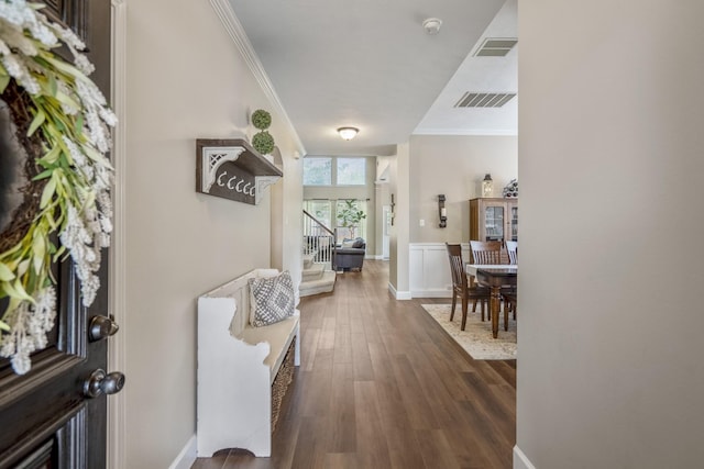 foyer with stairs, ornamental molding, dark wood-style floors, and baseboards