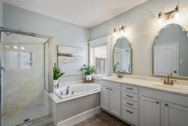 full bathroom featuring a shower stall, a garden tub, and double vanity