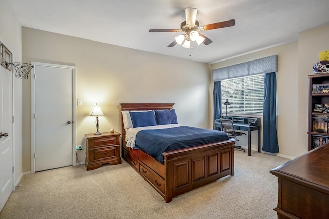 bedroom with light colored carpet, baseboards, and ceiling fan