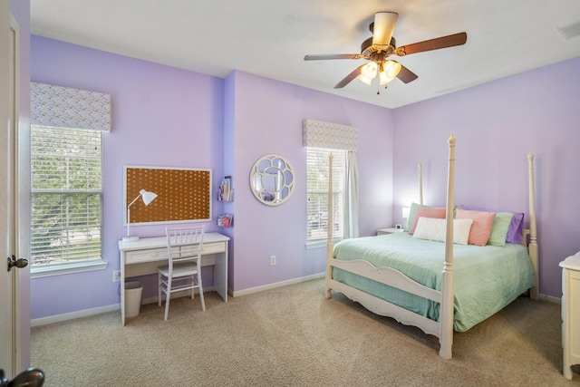 carpeted bedroom with multiple windows, baseboards, a ceiling fan, and an office area