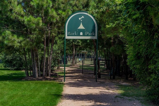 view of property's community with fence and a gate