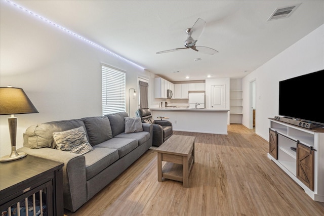 8834 Wooster Trails Dr, Baytown, TX 77521 - living room featuring recessed lighting, ceiling fan, visible vents, and light wood-style floors