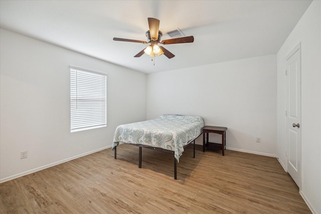 8834 Wooster Trails Dr, Baytown, TX 77521 - bedroom featuring visible vents, a ceiling fan, light wood-style flooring, and baseboards