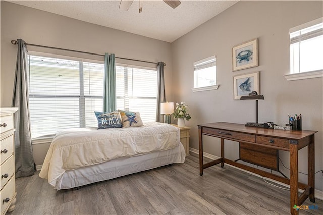106 Clement Cv, Port Lavaca, TX 77979 - bedroom featuring a textured ceiling, ceiling fan, wood finished floors, and baseboards