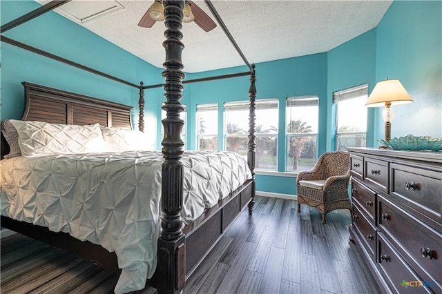 106 Clement Cv, Port Lavaca, TX 77979 - bedroom with a textured ceiling, ceiling fan, and dark wood-style floors