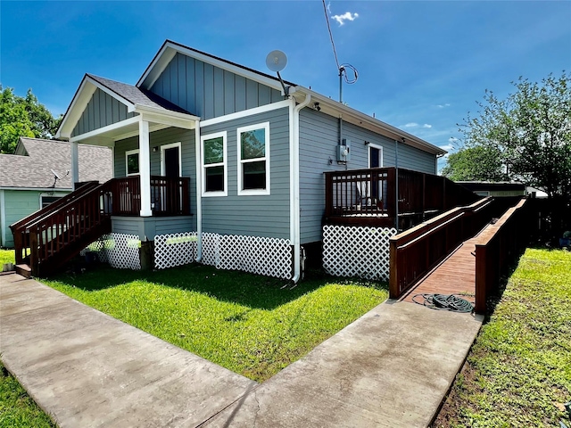 view of property exterior featuring a porch, a yard, and board and batten siding