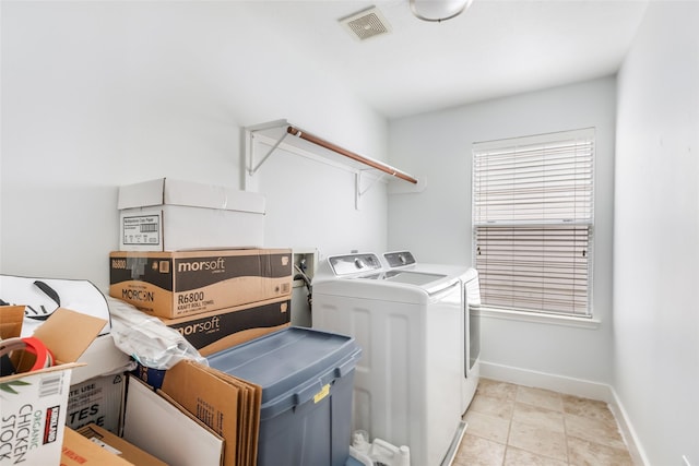 laundry area with washing machine and clothes dryer, laundry area, visible vents, and baseboards