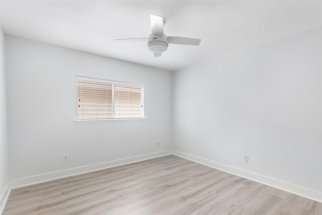 unfurnished room with baseboards, a ceiling fan, and light wood-type flooring