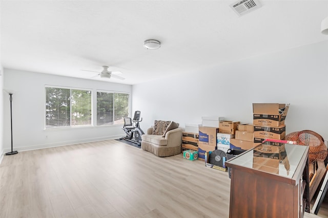 sitting room featuring baseboards, ceiling fan, visible vents, and wood finished floors