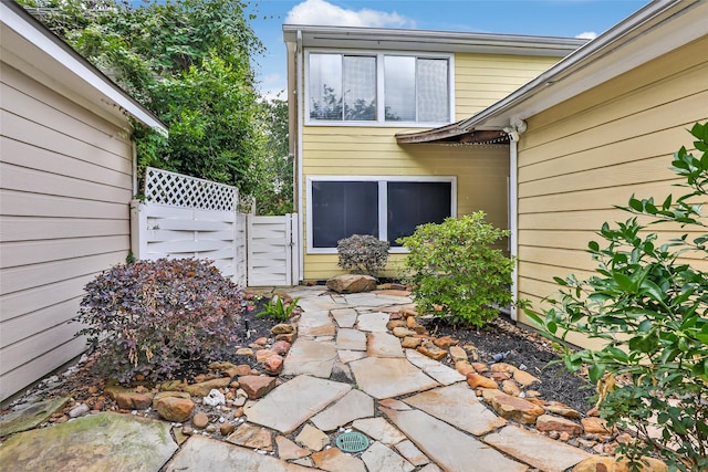 doorway to property with fence and a gate