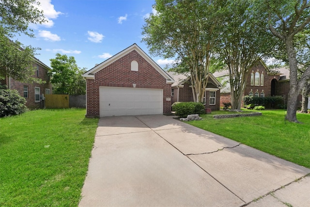 view of front facade featuring driveway, a front yard, fence, brick siding, and a garage