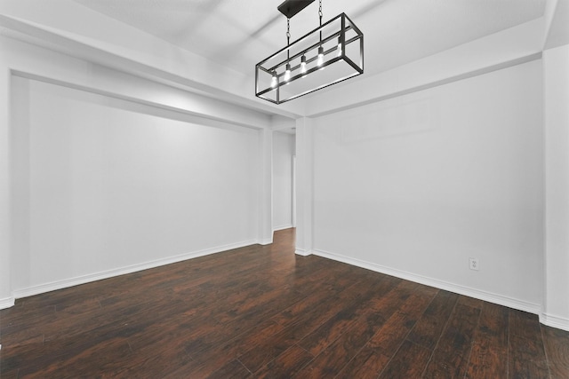 interior space with an inviting chandelier, dark wood-style flooring, and baseboards