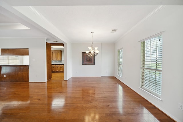 331 Moonshine Hill Rd, Houston, TX 77338 - unfurnished dining area featuring an inviting chandelier, hardwood / wood-style flooring, crown molding, and visible vents