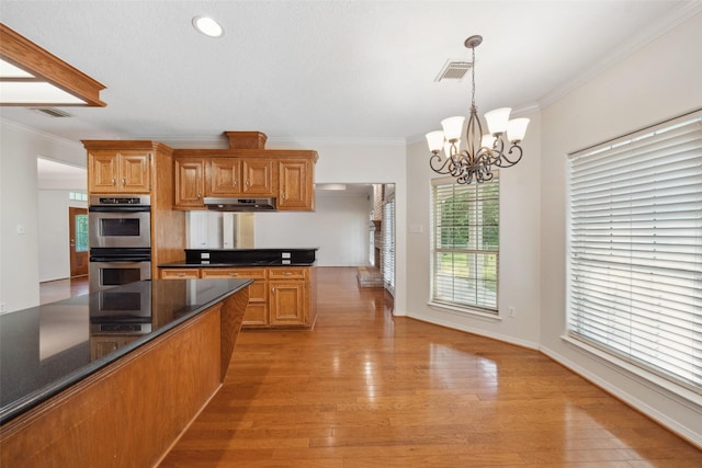 331 Moonshine Hill Rd, Houston, TX 77338 - kitchen with double oven, visible vents, a chandelier, crown molding, and dark countertops