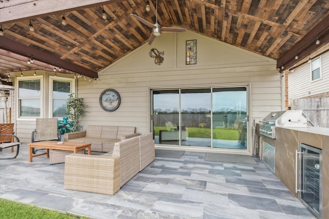 view of patio with ceiling fan, outdoor lounge area, a grill, wine cooler, and exterior kitchen