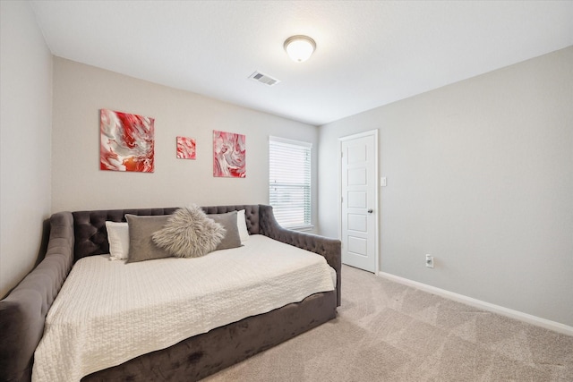 bedroom featuring baseboards, visible vents, and light colored carpet