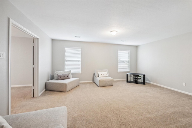 sitting room featuring baseboards, visible vents, and carpet flooring